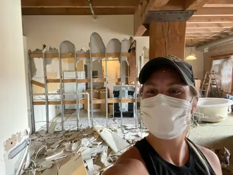 Keenan Brickson in a mask and cap during demolition of The Brix first condo in 2022