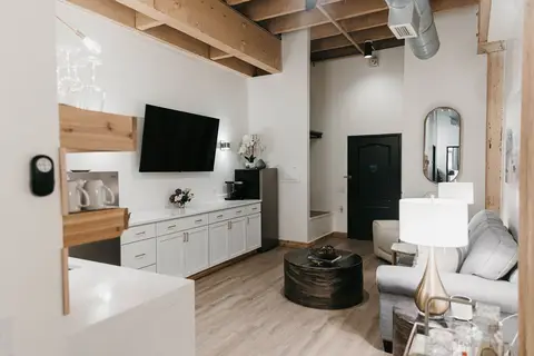 Dockside Suite 1 living area with wood beams and kitchenette