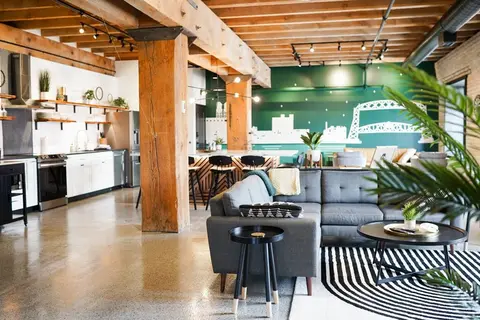 L'Etoile du Nord open living room and kitchen with a large green mural